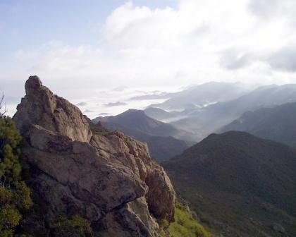 View of the ocean from Circle X Ranch with the clouds breaking across the jagged range.