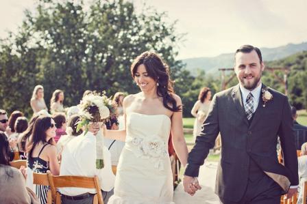 The bridge and groom hold each other's hand as they walk down the aisle and start their new life together.