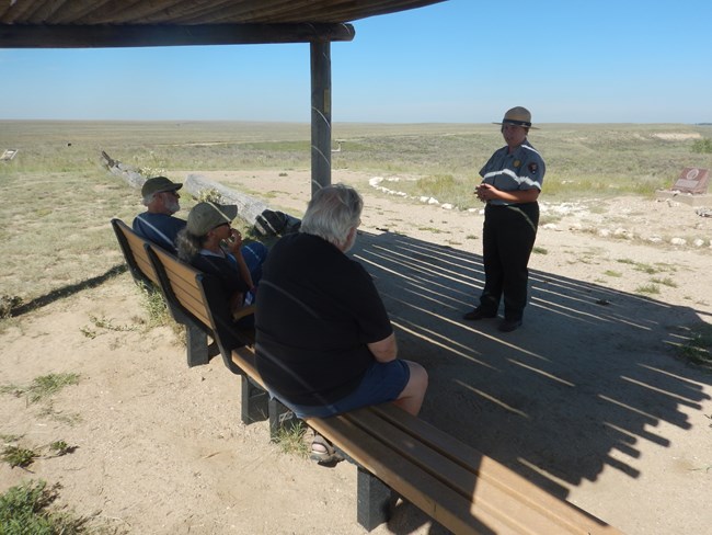 Park Ranger presenting program to park visitors on top of monument hill