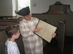 Boy looks at a map of church pews