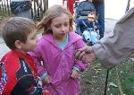 Children look at a handmade nail