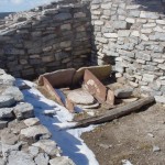Stone metate shown on floor of ruins