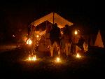 American soldiers outlined by campfire and lantern