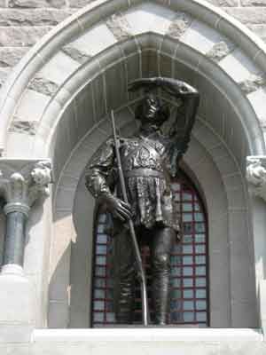 Bronze statue of American Colonel Daniel Morgan.  He raises his left hand to shield his eyes in the afternoon sun.