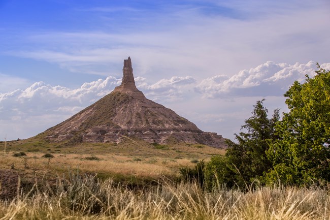 A distinctive sandstone formation rises like a chimney from the plains.
