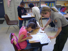 4th grade students investigating owl pellets during the Guess Hoo's for Dinner program.