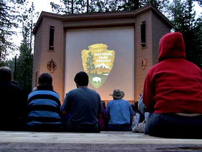 Visitors await the beginning of an evening campfire program in Lodgepole Amphitheater
