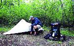 A backcountry camper preparing his campsite.