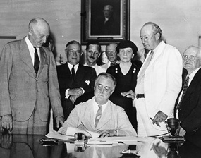 FDR signs Social Security Act, 1935