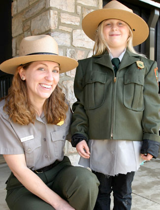 A ranger and a young visitor dressed up like a ranger at National Junior Ranger Day in Shenandoah.