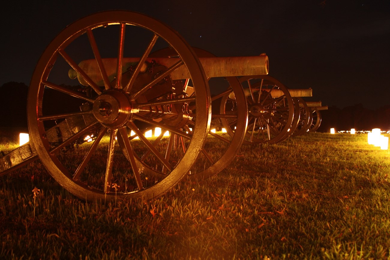 Artillery illuminated by candles