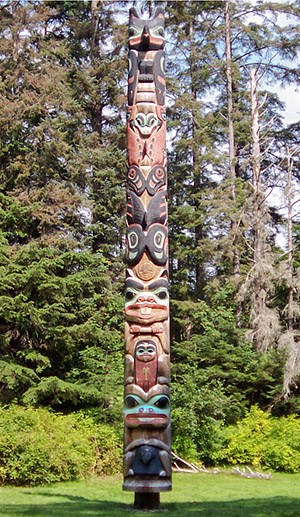 Colorful, wood carved totem pole in forest