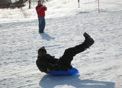 Boy on a saucer on the Dune Climb