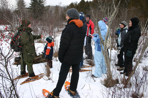 Visitors explore winter wonders off the beaten path on a Park Ranger-guided snowshoe hike at Sleeping Bear Dunes National Lakeshore.
