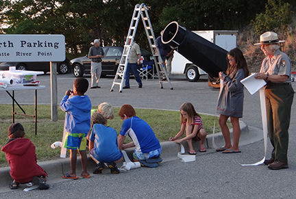 Young visitors record their observations at a Night Sky event at Sleeping Bear Dunes National Lakeshore.