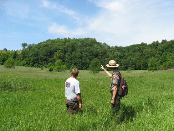 National Park Service Park Ranger describes the various ecosystems of Sleeping Bear Dunes National Lakeshore to a park visitor.  Photo courtesy of National Park Service.