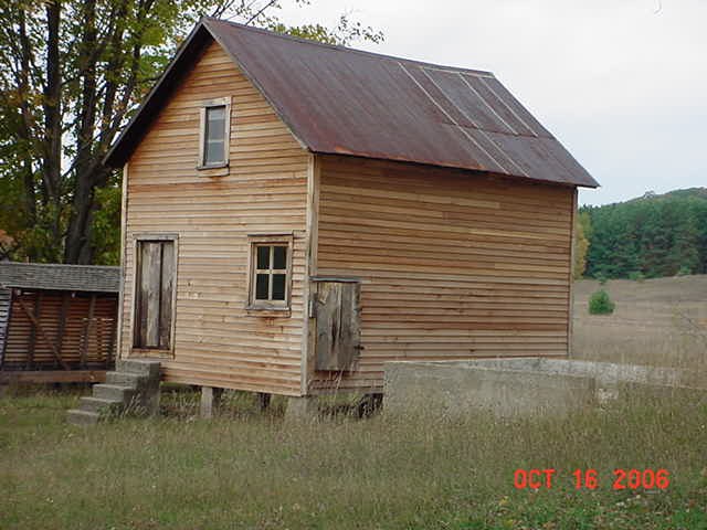 Wooden, narrow building with metal roof