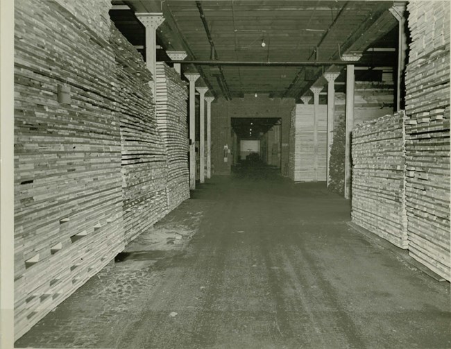 A black and white photo of gunstock blanks drying in Building 19.