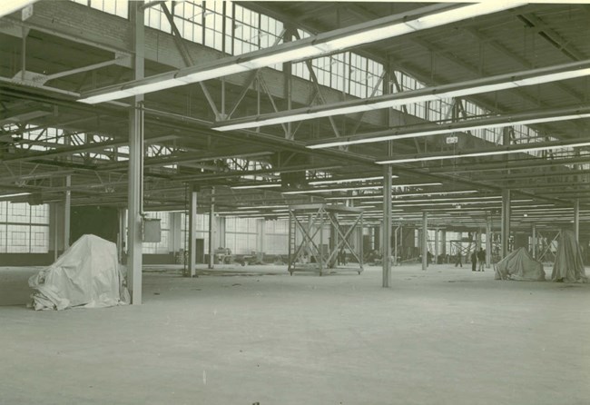 A black and white photo of the interior of a building under construction.
