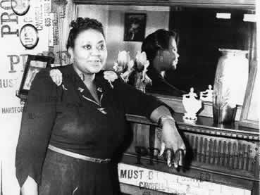 Canty in front of the second floor fireplace in her family home
