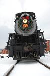 A steam loco with a wreath on the firebox door.