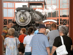 Visitors watch a steam locomotive on the turntable at Steamtown