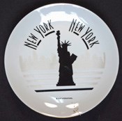 Black-on-white commemorative plate with a silhouette of the Statue of Liberty