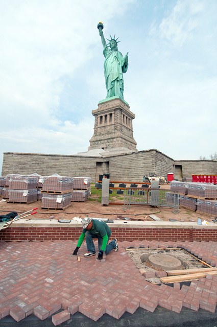 A contractor rebuilds the walkway on Liberty Island.