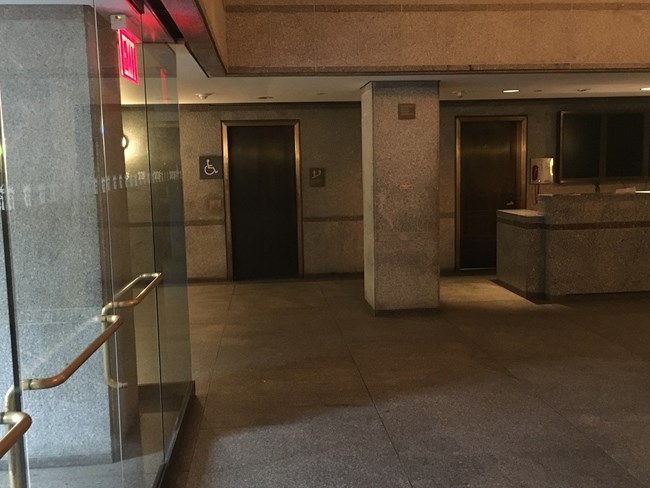 A picture of the first floor elevator door inside the lobby of the Statue of Liberty.