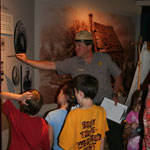 A ranger talks to children