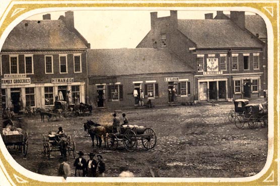 Historic photo showing wagons and stores on the Murfreesboro square.