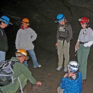 group of people in a cave with ranger