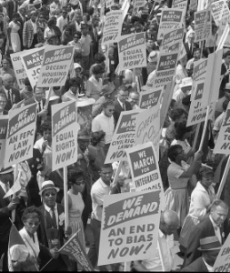 Demonstrators marching in the street holding signs during the March on Washington, August 28, 1963 Demonstrators marching in the street holding signs during the March on Washington, August 28, 1963