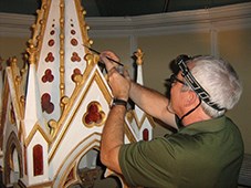Man painting a church icon