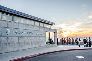Visitors at the Lands End Visitor Center view  the sunset over San Francisco Bay.