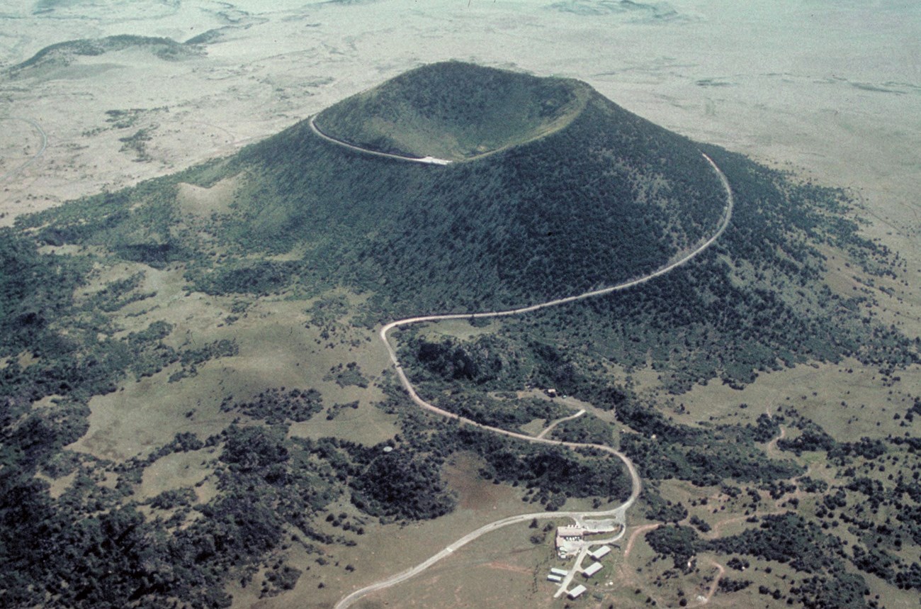 aerial view of a cinder cone showing visitor canter and road to the summit