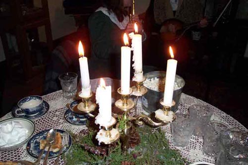 candles and greenery set the mood for the holiday event