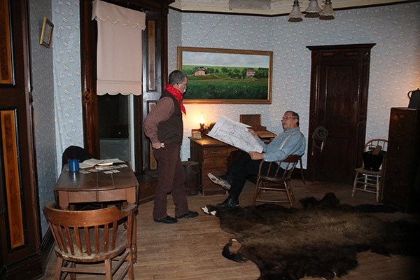 A subjective idea of how the historic office may have appeared. Historic reenactors portray a scene during a Candlelight Tour.