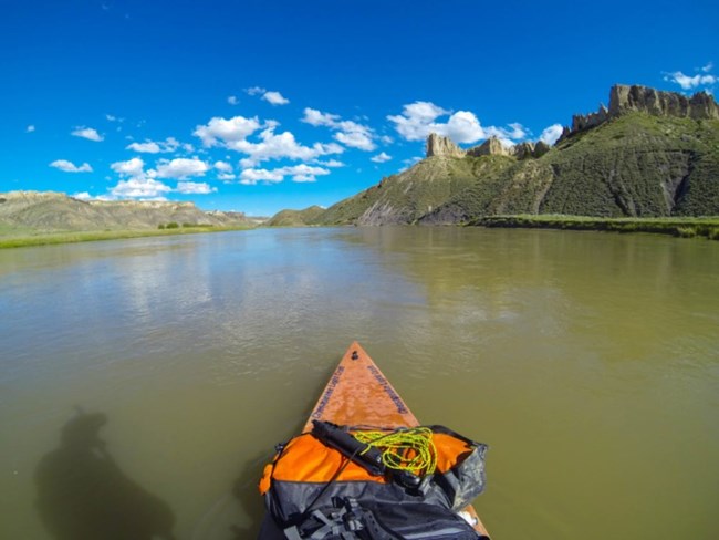 orange kayak on wide river
