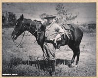 Theodore Roosevelt with his horse in the badlands.
