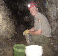 Ranger Andy Armstong removes tunnel fill debris to restore Lower Passage in Timpanogos Cave back to a natural state.
