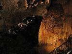 The formation on the right side of this photo, called flowstone, was made over thousands of years by flowing water carrying dissolved mineral. The flow of the water caused this formation to look very much like a frozen waterfall. 