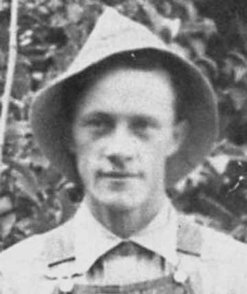 Black and white portrait of George Heber Hansen wearing a hat and overalls.