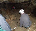 As you explore Hansen Cave, rope rigging helps you navigate a steep slide. 