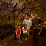 Delicate formations inside Chimes Chamber captivate a family on a ranger-led cave tour.