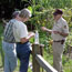  Volunteer talking with adult visitors.