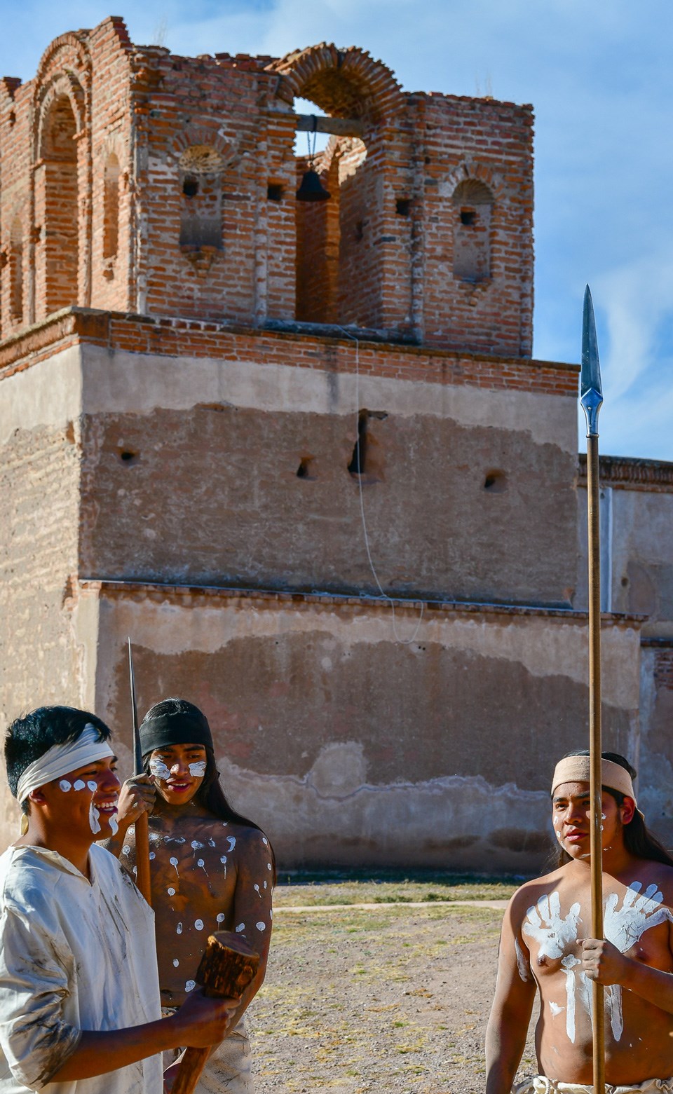 native people in traditional dress in front of church