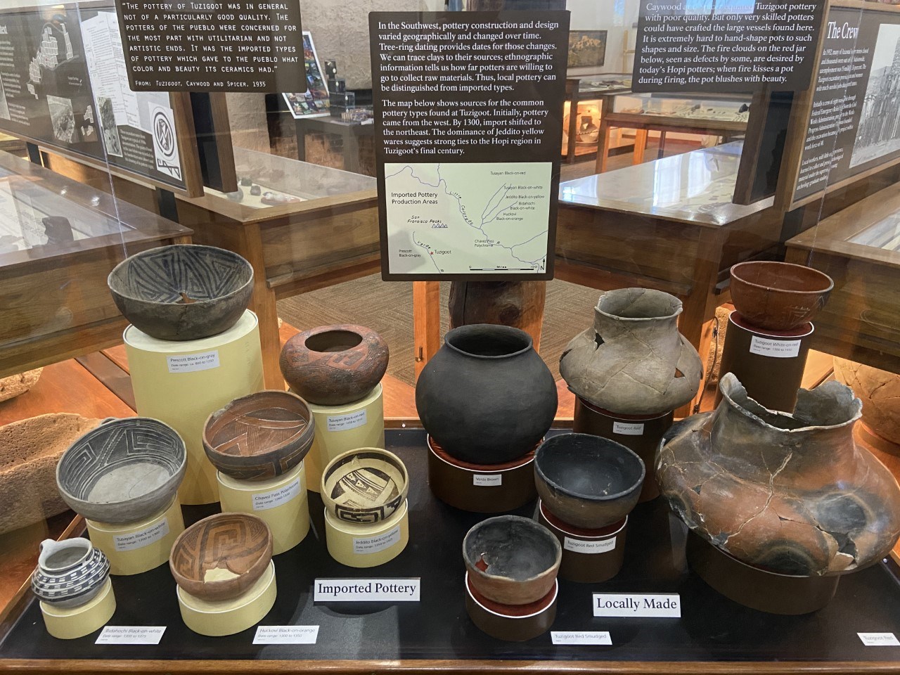 a museum case showing 7 ceramic vessels that were imported to Tuzigoot and 6 locally made ones