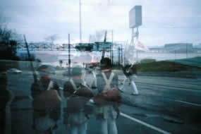 Shadowy continental soldiers are superimposed on a modern road.