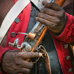 lock, stock, and barrel cover photo featuring african soldier holding musket